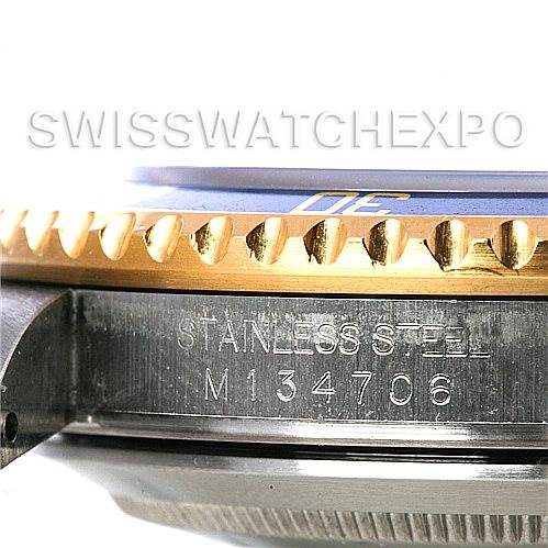 This image shows a close-up side view of a Rolex Submariner 16613 Men's Steel and Gold (two tone) Blue Dial 16613 Men's Steel and Gold (two tone) Blue Dial watch, focusing on the engraved case and the edge of its bezel.