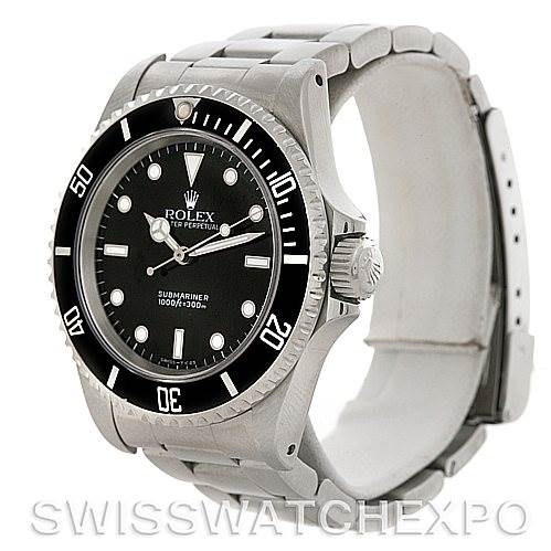 This photo shows a Rolex Submariner 14060M Men's Stainless Steel Black Dial 14060M Men's Stainless Steel Black Dial watch from an angled side view, highlighting the face, bezel, and a part of the bracelet.
