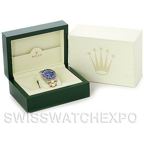 The image shows a Rolex Submariner 116613BLSO Men's Steel and Gold (two tone) Blue Dial 116613BLSO Men's Steel and Gold (two tone) Blue Dial watch in a green box with an open lid, next to a closed beige box displaying the Rolex logo.