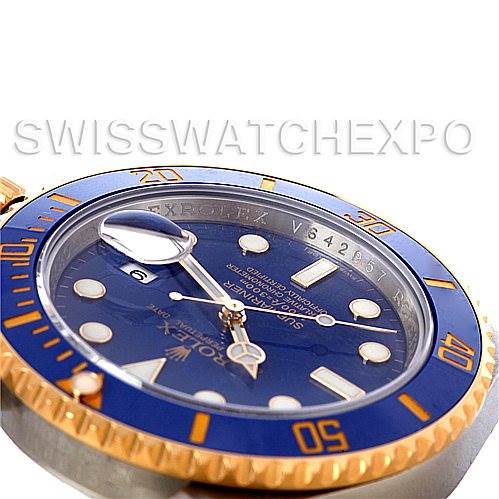 The image shows a partial close-up of the Rolex Submariner 116613BLSO Men's Steel and Gold (two tone) Blue Dial 116613BLSO Men's Steel and Gold (two tone) Blue Dial watch face, highlighting the blue and gold bezel, dial, and cyclops lens.