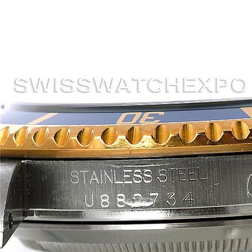 This image shows a close-up of the side of a Rolex Submariner 16613 Men's Steel and Gold (two tone) Blue Dial 16613 Men's Steel and Gold (two tone) Blue Dial watch, featuring the stainless steel case and part of the bezel.