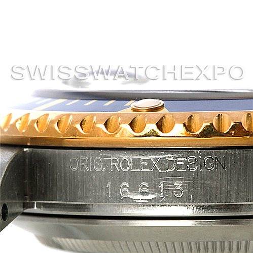 Close-up angle of a Rolex Submariner 16613 Men's Steel and Gold (two tone) Blue Dial 16613 Men's Steel and Gold (two tone) Blue Dial showing the side of the case with engraved details and part of the bezel.