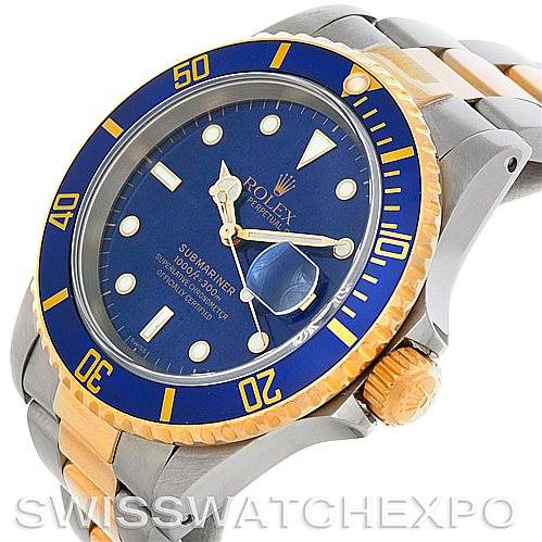 The image shows a Rolex Submariner 16613 Men's Steel and Gold (two tone) Blue Dial 16613 Men's Steel and Gold (two tone) Blue Dial watch viewed from an oblique angle, highlighting the case, bezel, dial, and bracelet.