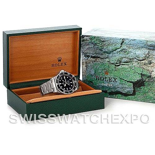 The image shows a Rolex Submariner 16610 Men's Stainless Steel Black Dial 16610 Men's Stainless Steel Black Dial watch at a front angle, displayed in an open green Rolex box with a marble-patterned sleeve.