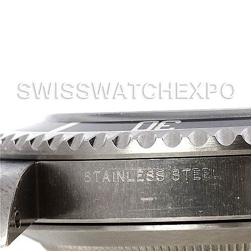 This image shows a close-up shot of the Rolex Submariner 14060M Men's Stainless Steel Black Dial 14060M Men's Stainless Steel Black Dial's stainless steel case and bezel from a side angle.