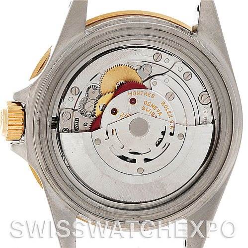 The image shows the open back of a Rolex Submariner 16613 Men's Steel and Gold (two tone) Grey Dial 16613 Men's Steel and Gold (two tone) Grey Dial watch, highlighting the intricate inner movement and mechanisms.