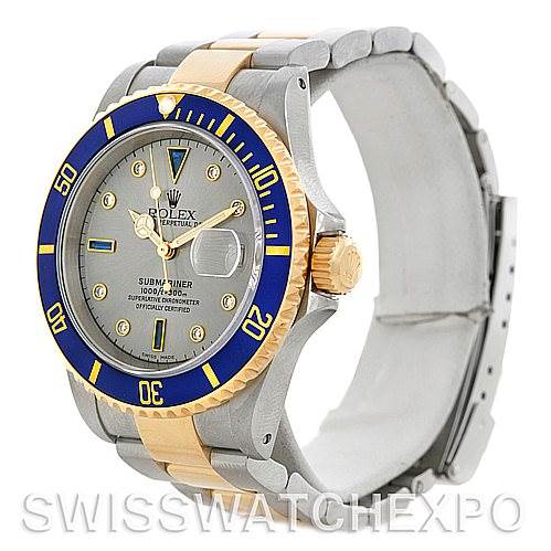 The Rolex Submariner 16613 Men's Steel and Gold (two tone) Grey Dial 16613 Men's Steel and Gold (two tone) Grey Dial watch is shown at a three-quarter angle, displaying the bezel, dial, crown, and part of the bracelet.