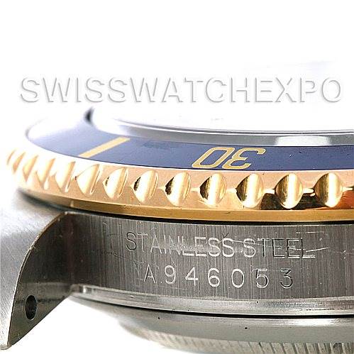 This image shows a close-up side view of the Rolex Submariner 16613 Men's Steel and Gold (two tone) Grey Dial 16613 Men's Steel and Gold (two tone) Grey Dial's bezel and case, highlighting the serial number and "STAINLESS STEEL" engraving.
