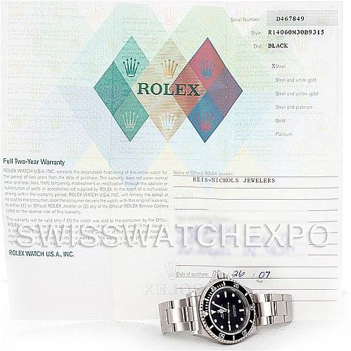 This image shows a Rolex watch positioned with its warranty card and documentation in the background.