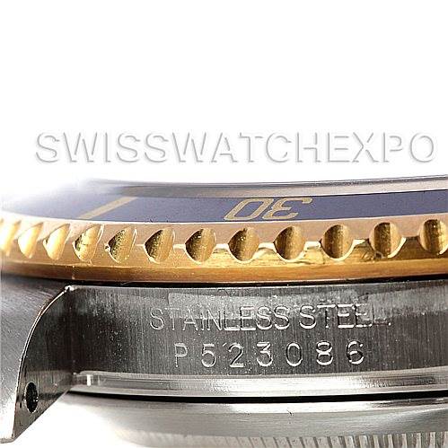 The image shows a close-up side angle of a Rolex Submariner 16613 Men's Steel and Gold (two tone) Blue Dial 16613 Men's Steel and Gold (two tone) Blue Dial, highlighting the bezel, part of the case, and the engraved serial number.