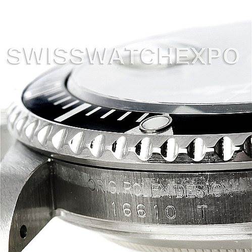 The image shows a close-up angle of the bezel and case side of a Rolex Submariner 16610 Men
s Stainless Steel Black Dial 16610 Men
s Stainless Steel Black Dial model, focusing on the serial engraving.