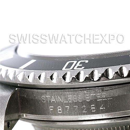 This image shows a close-up of the bezel and serial number on the side case of a Rolex Submariner 16610 Men's Stainless Steel Black Dial 16610 Men's Stainless Steel Black Dial watch.