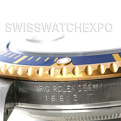 The image shows a close-up of a Rolex Submariner 16613 Men's Steel and Gold (two tone) Blue Dial 16613 Men's Steel and Gold (two tone) Blue Dial, highlighting its bezel and case side with engraved model number 16613T.