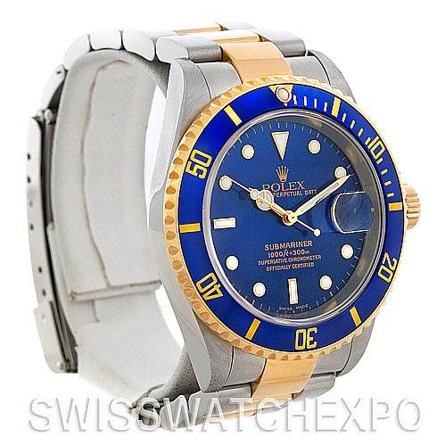 This image shows a Rolex Submariner 16613 Men's Steel and Gold (two tone) Blue Dial 16613 Men's Steel and Gold (two tone) Blue Dial model from a front-left angle, highlighting its blue dial, bezel, and two-tone bracelet.