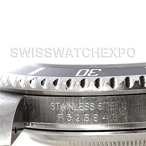 The image shows a close-up of the side profile of a Rolex Submariner 16610 Men's Stainless Steel Black Dial 16610 Men's Stainless Steel Black Dial watch, focusing on the bezel, case, and part of the serial number.