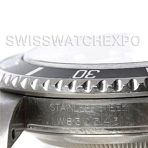 The image shows a close-up side view of the bezel and case of a Rolex Submariner 16610 Men's Stainless Steel Black Dial 16610 Men's Stainless Steel Black Dial, including its serial number.
