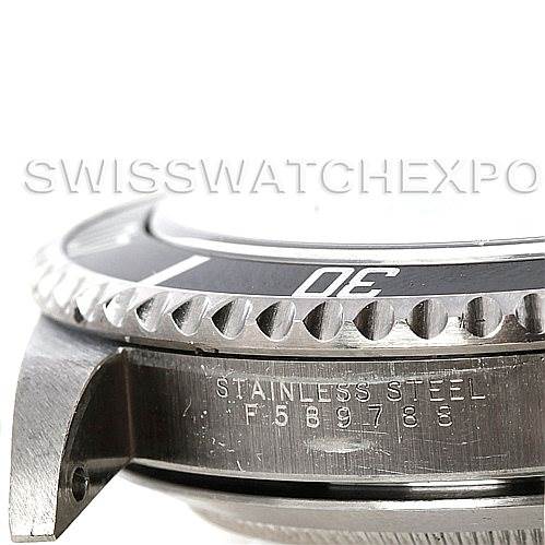 The image shows a close-up angled view of the Rolex Submariner 14060 Men
s Stainless Steel Black Dial 14060 Men
s Stainless Steel Black Dial watch
s bezel, lug, and stainless steel case with serial engraving.