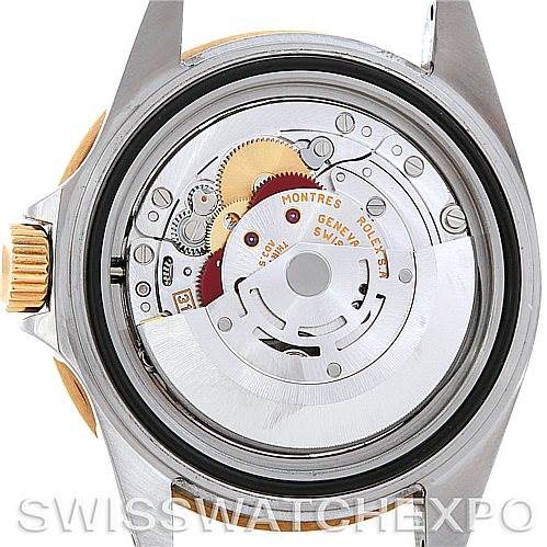 The image shows a close-up view of the Rolex Submariner 16613 Men's Steel and Gold (two tone) Blue Dial 16613 Men's Steel and Gold (two tone) Blue Dial's back, revealing its internal mechanical movement.