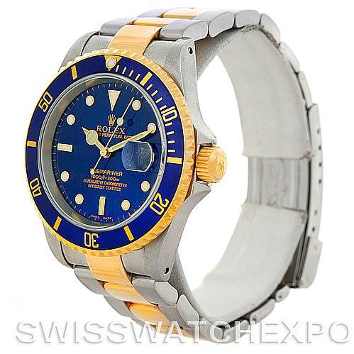 This image shows a Rolex Submariner 16613 Men's Steel and Gold (two tone) Blue Dial 16613 Men's Steel and Gold (two tone) Blue Dial watch at an angle highlighting the case, bezel, crown, and bracelet with a view of the dial.