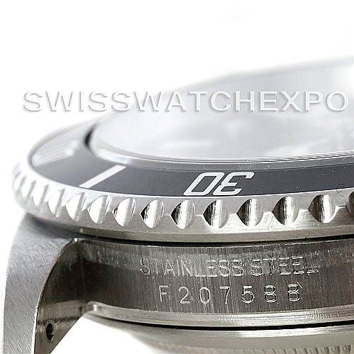 The image shows a close-up side view of a Rolex Submariner 16610 Men's Stainless Steel Black Dial 16610 Men's Stainless Steel Black Dial watch focusing on its bezel, case, and serial number.