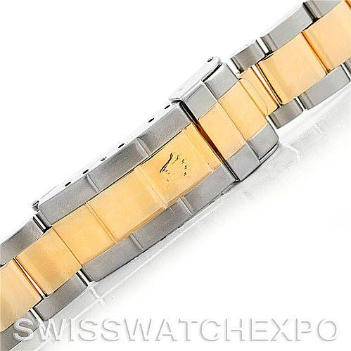This image shows a close-up of a Rolex Submariner 16613 Men's Steel and Gold (two tone) Grey Dial 16613 Men's Steel and Gold (two tone) Grey Dial watch bracelet, highlighting its two-tone design featuring gold and stainless steel.