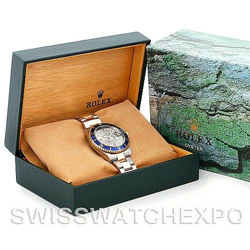 The Rolex Submariner 16613 Men's Steel and Gold (two tone) Grey Dial 16613 Men's Steel and Gold (two tone) Grey Dial watch is displayed in an open wooden box with an additional outer box visible beside it.