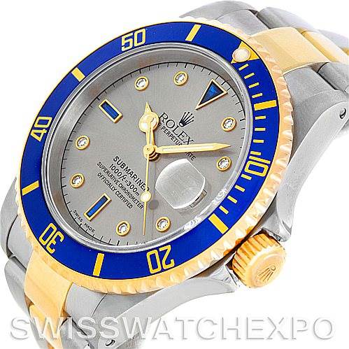 The image shows a Rolex Submariner 16613 Men's Steel and Gold (two tone) Grey Dial 16613 Men's Steel and Gold (two tone) Grey Dial watch at an angle displaying the face, bezel, and part of the bracelet.