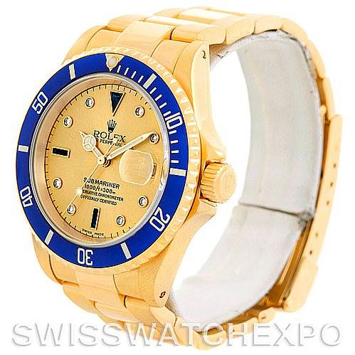 The image shows a Rolex Submariner 16618 Men's Yellow Gold Champagne Dial 16618 Men's Yellow Gold Champagne Dial watch viewed at an angled side profile, displaying its gold bracelet, blue bezel, and gold dial.
