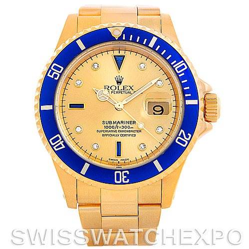 The image shows a front view of the Rolex Submariner 16618 Men's Yellow Gold Champagne Dial 16618 Men's Yellow Gold Champagne Dial watch with a gold case, blue bezel, and champagne dial.