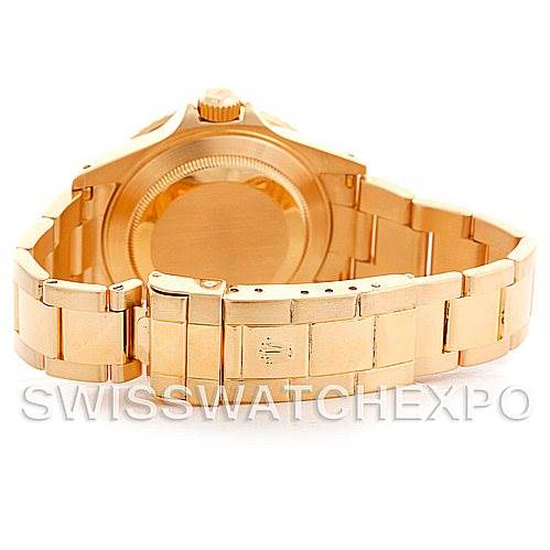 The image shows the back view of a Rolex Submariner 16618 Men's Yellow Gold Champagne Dial 16618 Men's Yellow Gold Champagne Dial watch, highlighting its gold bracelet and clasp.