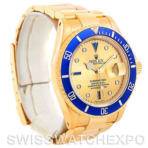 This image shows a Rolex Submariner 16618 Men's Yellow Gold Champagne Dial 16618 Men's Yellow Gold Champagne Dial watch at an oblique angle, highlighting the gold case, blue bezel, dial, and bracelet.