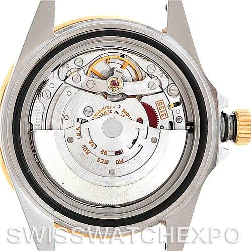 The image shows the back view of a Rolex Submariner 16613 Men's Steel and Gold (two tone) Blue Dial 16613 Men's Steel and Gold (two tone) Blue Dial watch, revealing its open mechanical movement and internal components.