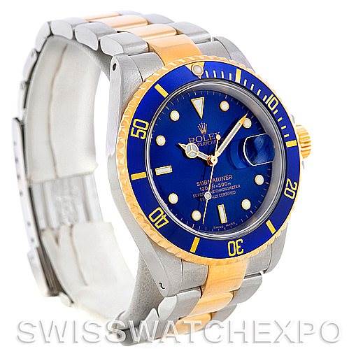 This image shows a Rolex Submariner 16613 Men's Steel and Gold (two tone) Blue Dial 16613 Men's Steel and Gold (two tone) Blue Dial watch from an angled side view, highlighting the blue dial, gold bezel, and two-tone bracelet.