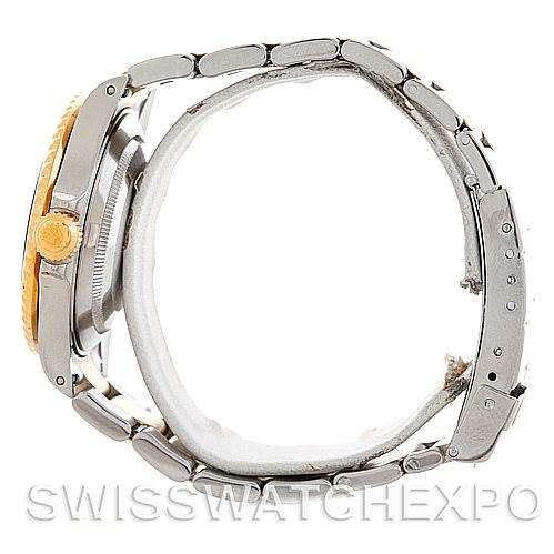 This side view of the Rolex Submariner 16613 Men's Steel and Gold (two tone) Blue Dial 16613 Men's Steel and Gold (two tone) Blue Dial watch showcases its bracelet, case, and crown.