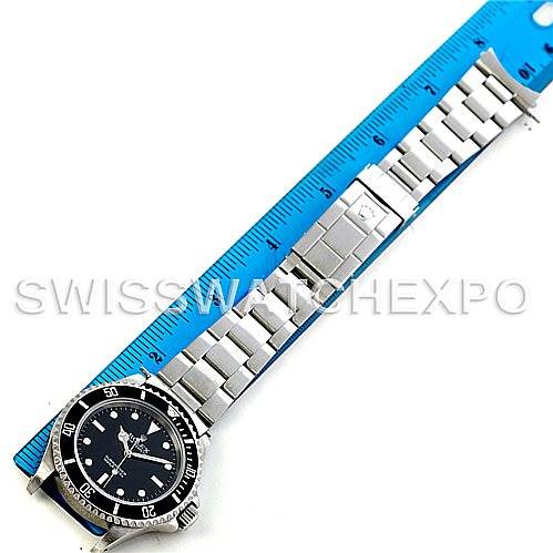 The image shows the full Rolex Submariner 14060 Men's Stainless Steel Black Dial 14060 Men's Stainless Steel Black Dial watch laid flat next to a ruler, showcasing its face and metal bracelet.