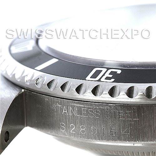 The image shows a close-up side angle of a Rolex Submariner 14060 Men's Stainless Steel Black Dial 14060 Men's Stainless Steel Black Dial watch, highlighting its bezel, stainless steel casing, and part of the serial number.