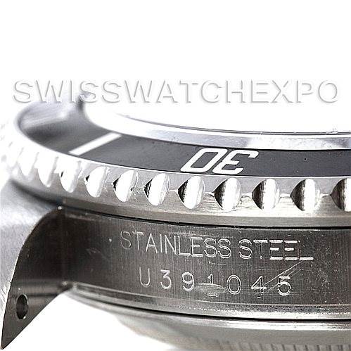 This image shows a close-up side view of the bezel and serial number of a Rolex Submariner 16610 Men's Stainless Steel Black Dial 16610 Men's Stainless Steel Black Dial watch.