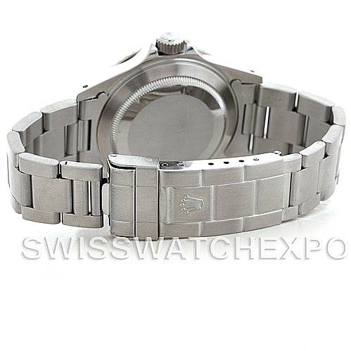 This image shows the backside of a Rolex Submariner 14060 Men's Stainless Steel Black Dial 14060 Men's Stainless Steel Black Dial watch, highlighting its stainless steel bracelet and clasp.