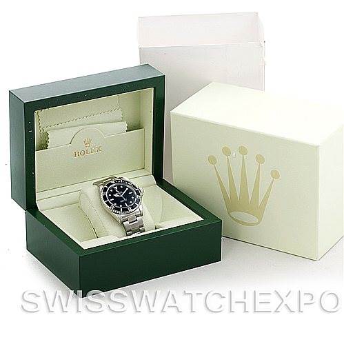 A Rolex Submariner 14060 Men's Stainless Steel Black Dial 14060 Men's Stainless Steel Black Dial watch is shown inside its green presentation box, along with an outer box and guarantee card sleeve.