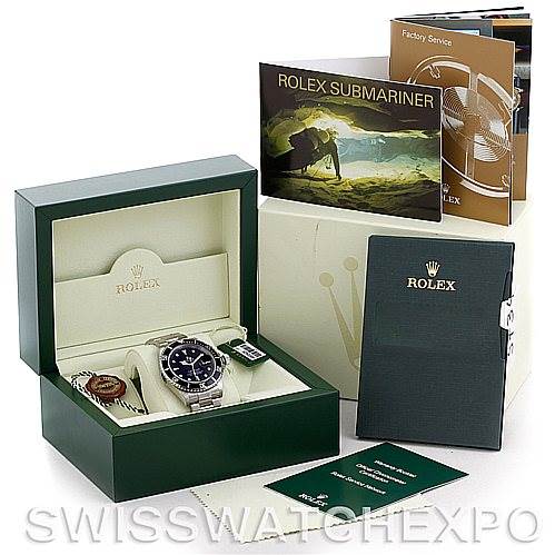 The image shows a Rolex Submariner 16610 Men
s Stainless Steel Black Dial 16610 Men
s Stainless Steel Black Dial watch in its box, with accompanying booklets and accessories displayed around it.