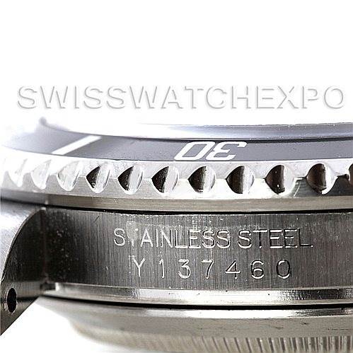 This image shows a close-up of the side profile of a Rolex Submariner 16610 Men
s Stainless Steel Black Dial 16610 Men
s Stainless Steel Black Dial watch, focusing on the bezel and the engraved serial number.