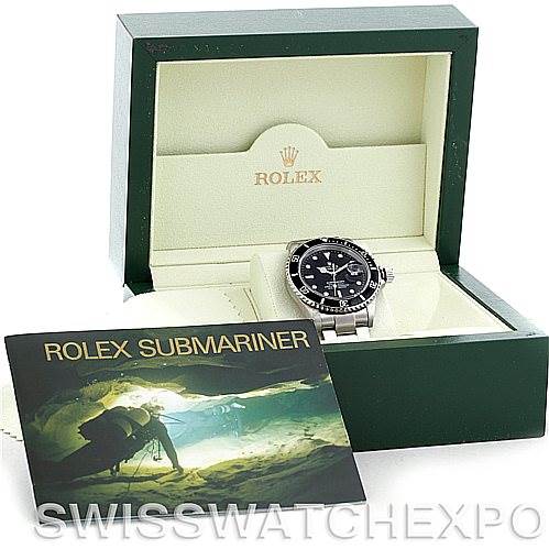 The image displays the Rolex Submariner 16610 Men
s Stainless Steel Black Dial 16610 Men
s Stainless Steel Black Dial watch, its green box, and a booklet, all viewed from a straight-front angle.