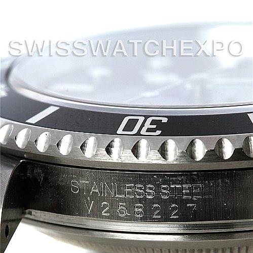 The image shows a close-up side view of the bezel and case of a Rolex Submariner 16610 Men
s Stainless Steel Black Dial 16610 Men
s Stainless Steel Black Dial watch, highlighting the serial number and "STAINLESS STEEL" engraving.