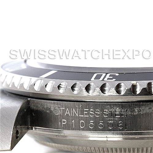 The image shows a close-up view of the side of a Rolex Submariner 16610 Men
s Stainless Steel Black Dial 16610 Men
s Stainless Steel Black Dial, focusing on the bezel and part of the case with the serial number.