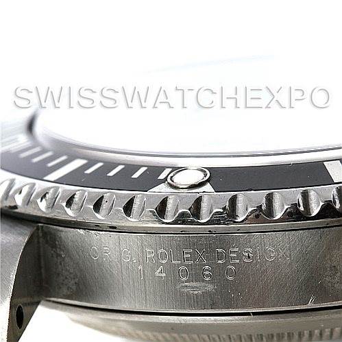The image shows a close-up side view of the Rolex Submariner 14060 Men
s Stainless Steel Black Dial 14060 Men
s Stainless Steel Black Dial watch, focusing on the bezel and the case with engraved text.