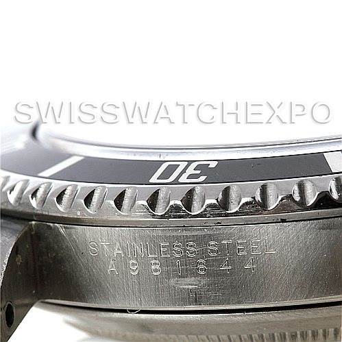 This image shows a close-up of the bezel and case side of a Rolex Submariner 14060 Men
s Stainless Steel Black Dial 14060 Men
s Stainless Steel Black Dial watch, focusing on the stainless steel engraving and serial number.