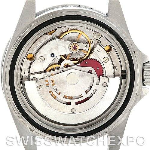 The image shows the open case back of a Rolex Submariner 14060 Men
s Stainless Steel Black Dial 14060 Men
s Stainless Steel Black Dial watch, revealing its internal mechanical movement and components.