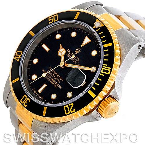 The image shows a Rolex Submariner 16613 Men
s Steel and Gold (two tone) Black Dial 16613 Men
s Steel and Gold (two tone) Black Dial watch at a slight angle, highlighting its dial, bezel, crown, and parts of the bracelet.