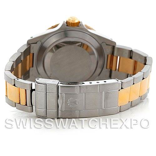 The image shows the backside and bracelet of a Rolex Submariner 16613 Men
s Steel and Gold (two tone) Black Dial 16613 Men
s Steel and Gold (two tone) Black Dial watch, highlighting its clasp and two-tone metal band.