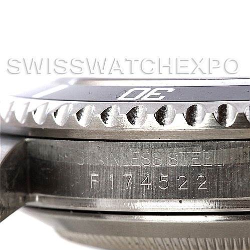 The image shows a close-up side view of a Rolex Submariner 16610 Men
s Stainless Steel Black Dial 16610 Men
s Stainless Steel Black Dial watch, highlighting the bezel, edge of the case, and the engraved serial number.